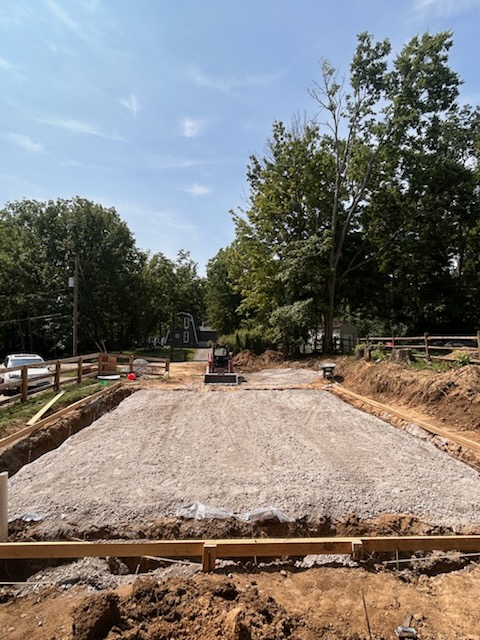 Building pad graded and formed on a compacted gravel base, ready for a large concrete slab pour