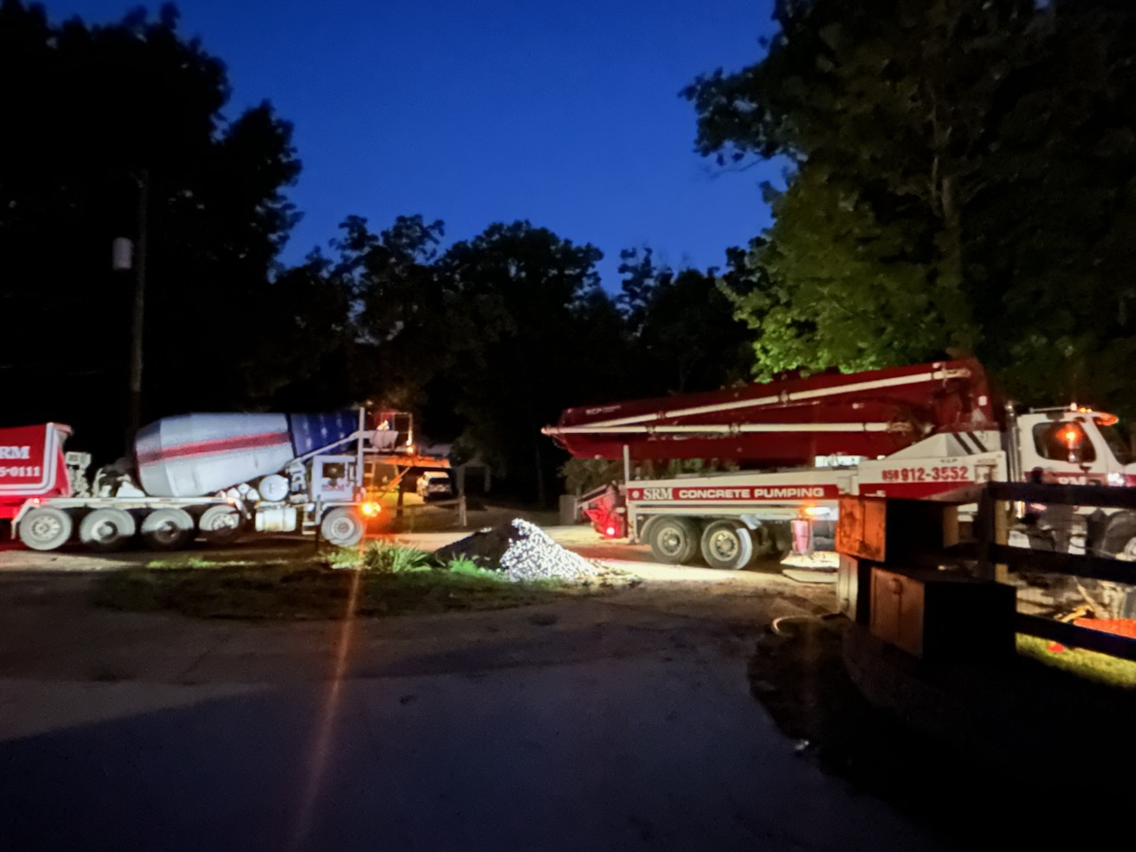 Concrete mixer and pump truck delivering an early-morning slab pour